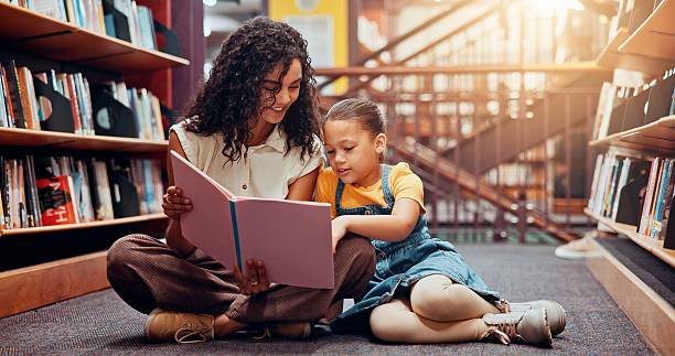 istock Child, learning or teacher reading book for storytelling, development or growth in school. Teaching, tutor or woman with girl or kid in library for literature lesson, fairy tale or education support 2229544245