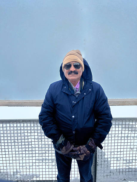 Joyful man is posing in Europe highest point Jungfraujoch Switzerland