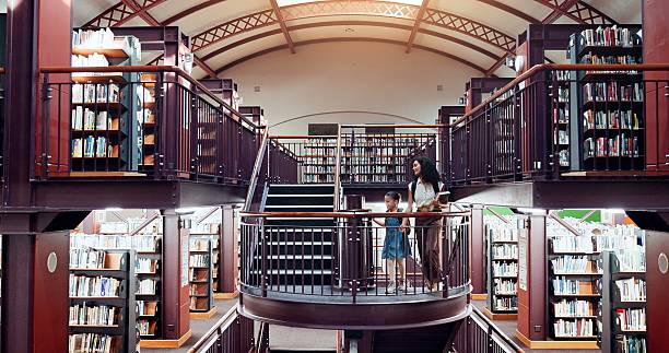istock Woman, girl and library stairs with study for information, learning or knowledge for academic tutor. Book session, student development and education with teacher, scholarship and walking people 2229544631