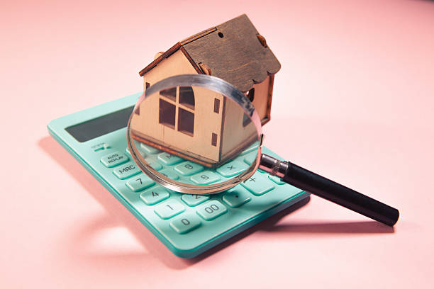 istock house model with calculator on a blue background. 2229545116