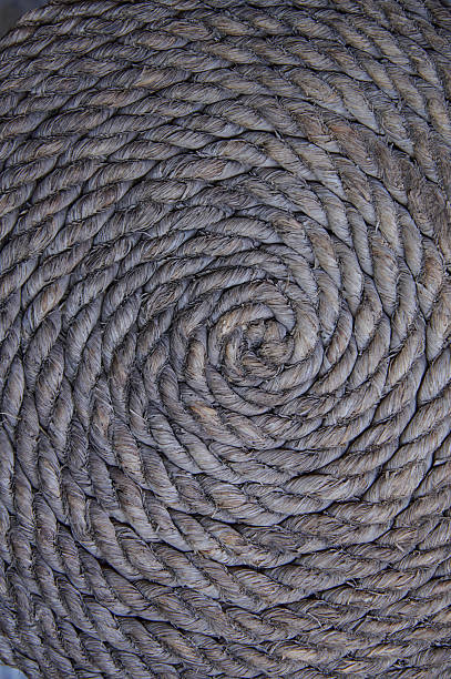Close up textured spiral pattern of thick natural fiber rope