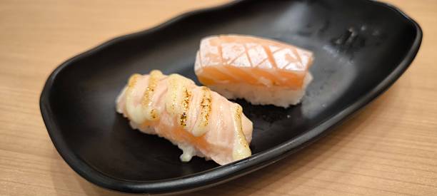 istock Sushi on a black plate on a wooden table 2229546080