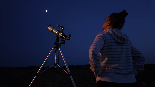 istock Amateur astronomer using telescope for watching stars, Moon, planets and other celestial objects from a field in nature. 2229546205