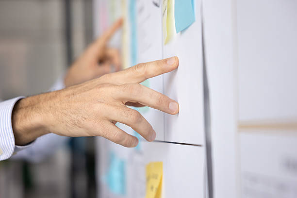 istock Hand of business project manager man pointing at whiteboard 2229547695