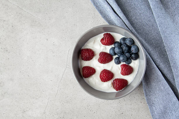 istock Gray ceramic bowl and natural yogurt with berries on the stone marble table. 2229549200