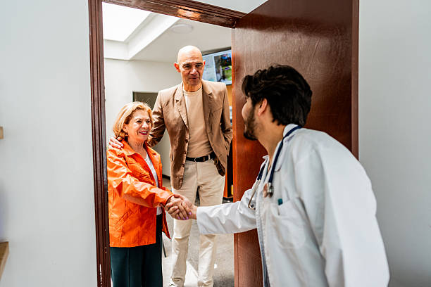 Doctor greeting senior patient at doctor's office