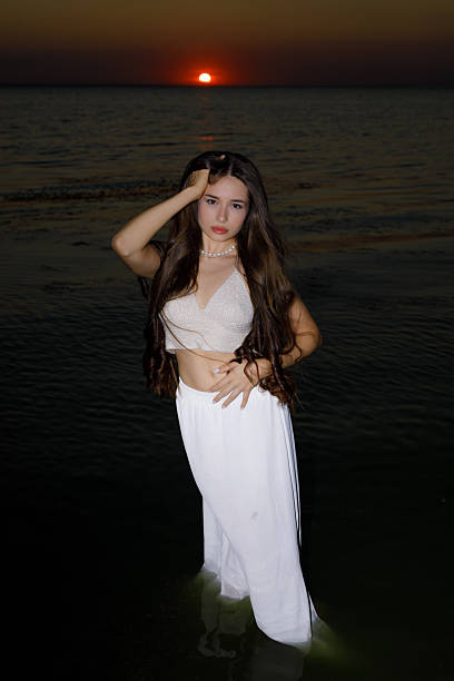 istock Young woman at water's edge 2229552247