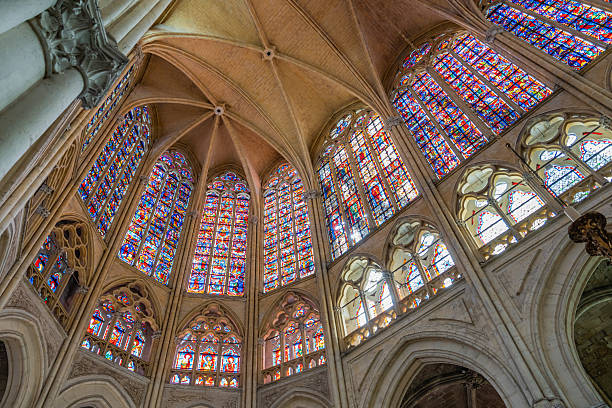 Bottom view of colorful stained-glass windows and renovated marble walls and structures inside Notre Dame´s Cathedral in Paris after its restoration