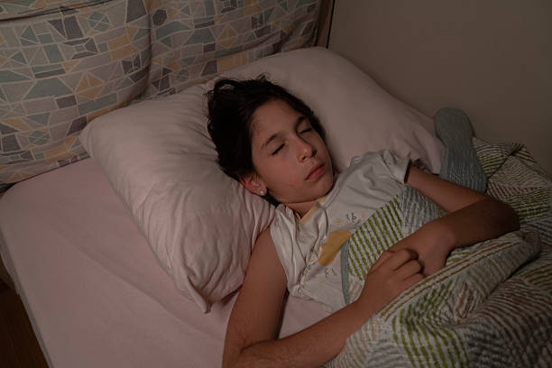istock Little Girl Sleeping In Her Bed At Night. 2229553170
