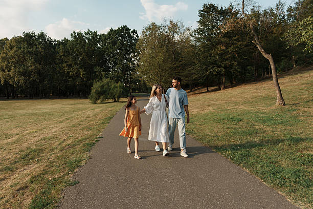 Family enjoying a walk together in a beautiful sunny park setting