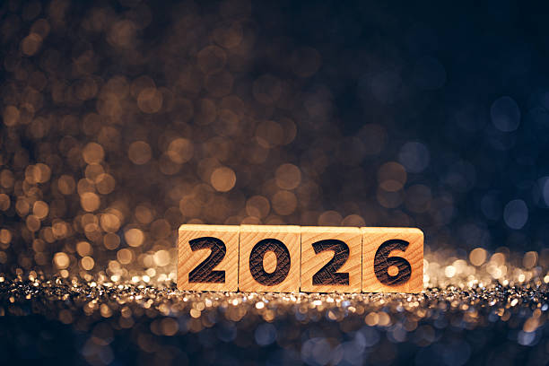 istock Wooden 2026 Year Blocks on Sparkling Glitter Surface with Festive Bokeh Lights 2229553769
