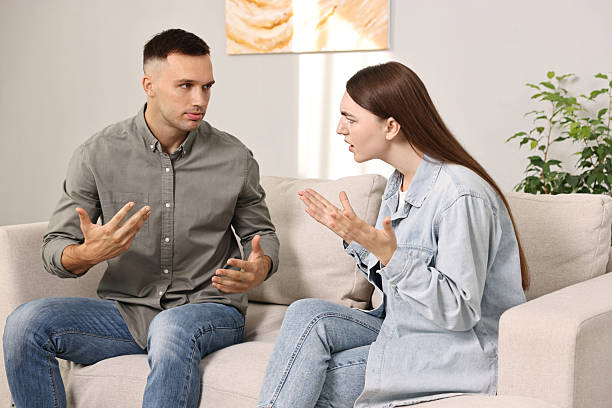 istock Young couple arguing on sofa at home 2229554867