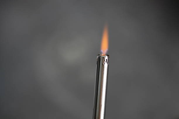 A lit matchstick with a flame burning brightly.