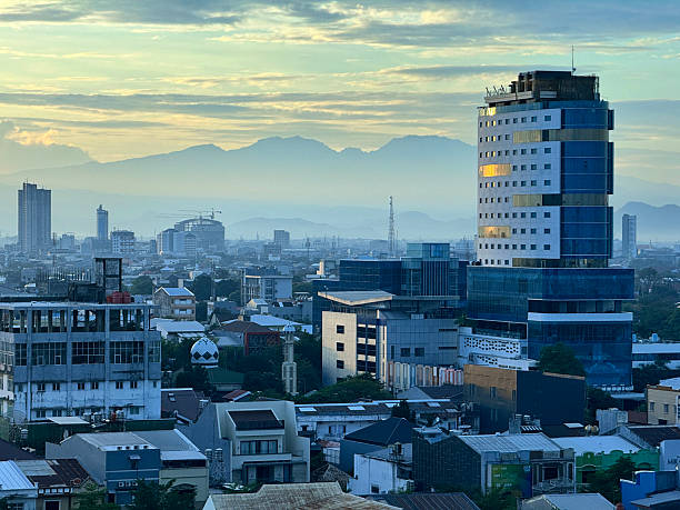 istock Modern City Skyline at Sunrise with Mountain Backdrop 2229556101