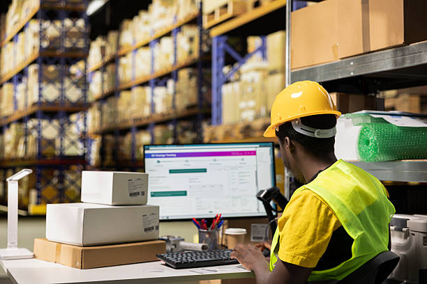 istock Large business warehouse staff processing orders with awb for online tracking 2229557011