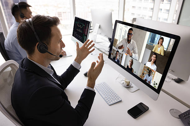 istock Focused contact center manager man in headset talking to colleagues 2229557536