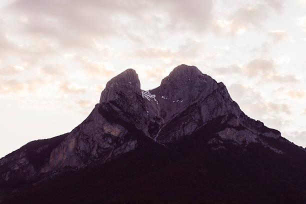 Towards sunset.The sun hits the mountain.Clear sky.Foreground silhouette forest landscape,in the shade.Nature landscape
