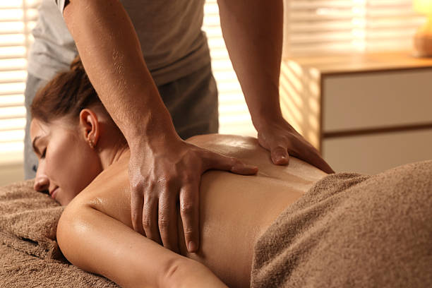istock Osteopath massaging woman's back on couch indoors, closeup. Manual therapy 2229559999