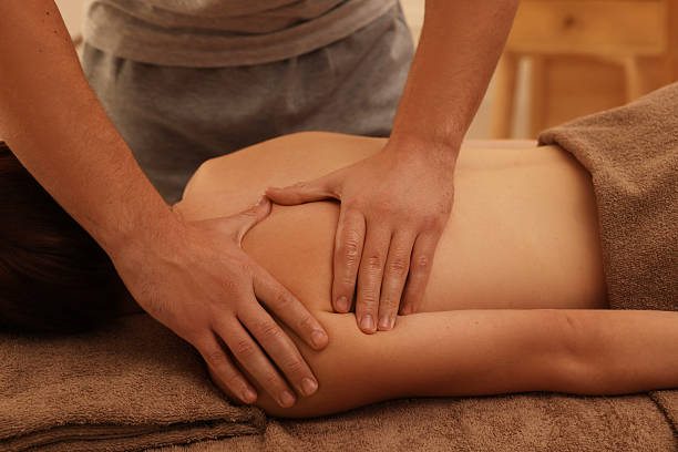istock Osteopath massaging woman's back on couch indoors, closeup. Manual therapy 2229560032