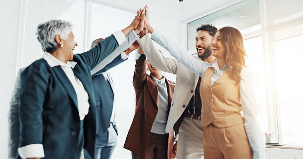 istock Happy people, teamwork and high five in office for goal, collaboration or corporate target. Smile, staff mission or group of employees in celebration for partnership, agreement or business success 2229560667