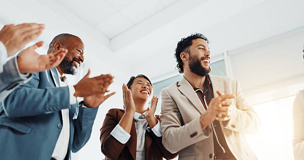 istock Clapping, success or excited business people in office for congratulations, seminar or celebration. Low angle, winner or applause of audience for goal, motivation and awards for target achievement 2229560672