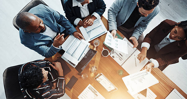 istock Documents, conversation and business people in office in collaboration for finance proposal from above. Paperwork, discussion and team of financial advisors with investment statistics for forecasting 2229560739