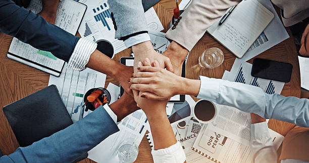 istock Hands, stack and above at meeting with documents, finance, support and team work at office. Business people, group and circle with link, motivation or synergy with celebration for revenue at company 2229560784
