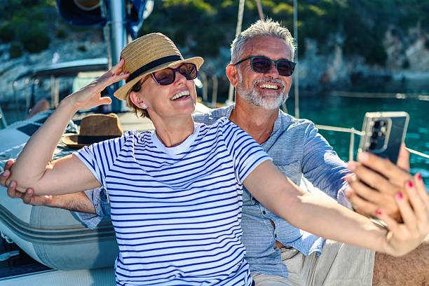 istock Senior couple taking a selfie on a sailboat 2229561367