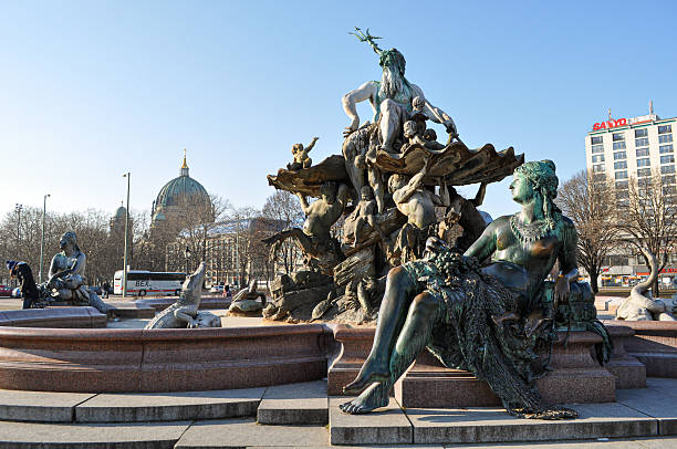 historic statue in in front of TV-Tower in Berlin under blue december sky