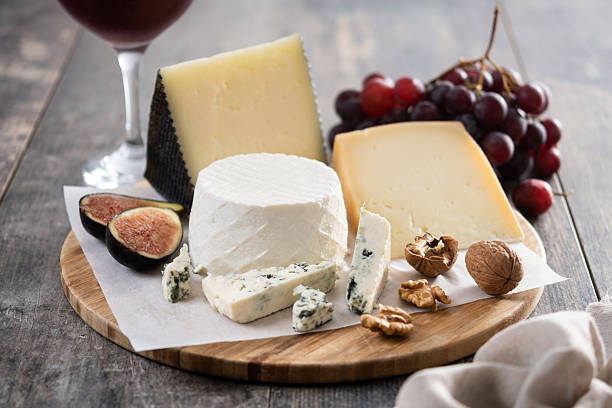 istock Board of different cheeses with nuts, figs, grapes and wine 2229564304