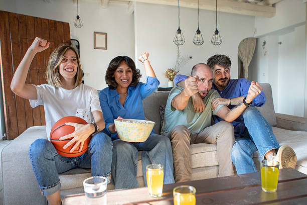 istock Friends watching a basketball game on TV 2229564731