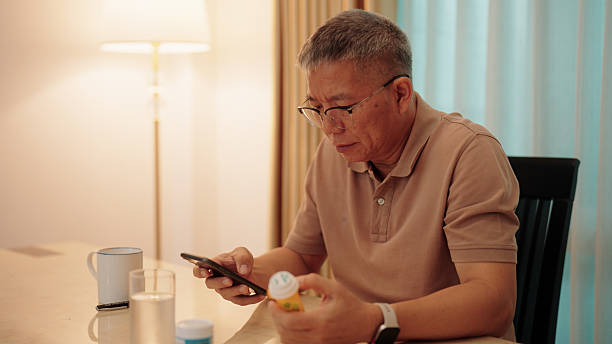 istock Asian elderly man reading a medication label with the help of his smartphone 2229564737