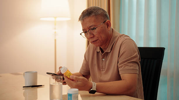 istock Asian elderly man reading a medication label with the help of his smartphone 2229564749