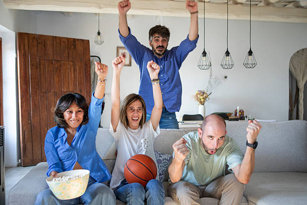 istock Friends watching a basketball game on TV 2229565278