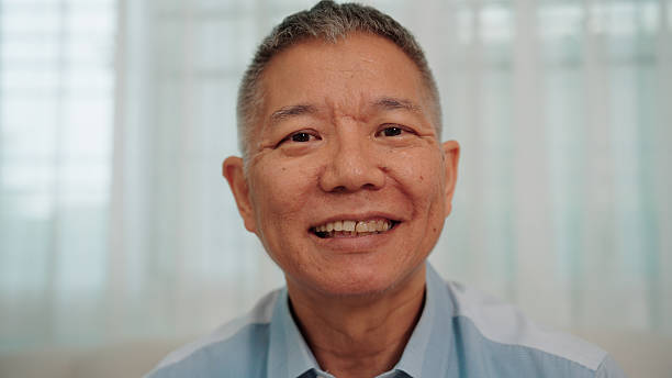 istock Confident elderly Asian man facing the camera with a contented smile and confidence 2229565284