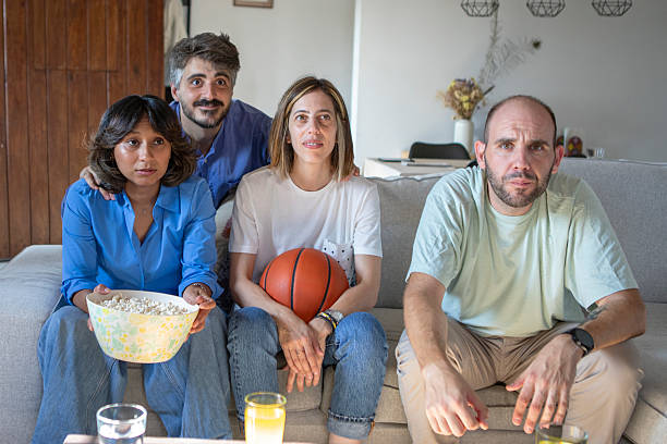 istock Friends watching a basketball game on TV 2229565481