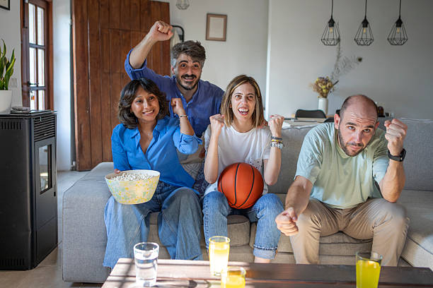 istock Friends watching a basketball game on TV 2229565491