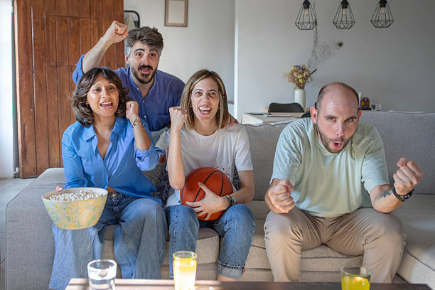 istock Friends watching a basketball game on TV 2229565576