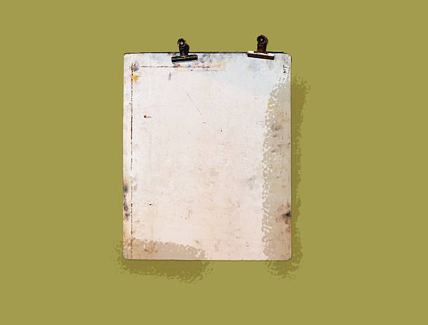 istock An old metal clipboard with aged white surface and rusted clips is displayed against a muted olive green background 2229566639