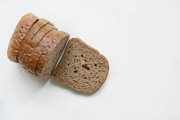 Detailed close-up of sliced grain bread on white background