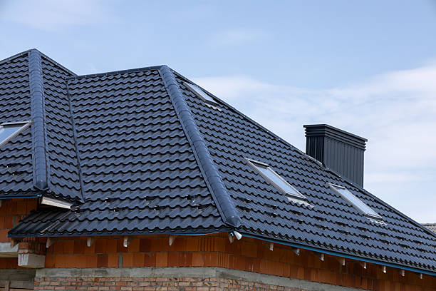 istock A modern home features a newly installed black tile roof with skylights under a bright blue sky, showcasing elegant design and craftsmanship 2229568913
