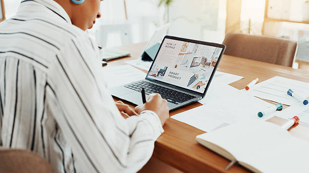 istock Corporate, woman and writing notes in office for planning, reminder and information on smart product. Back, female person and laptop screen for sales presentation, launch schedule and research report 2229571107