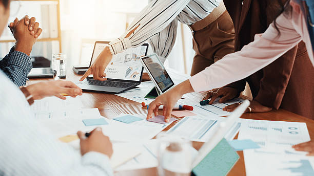 istock Business people, hands and planning in meeting, documents and laptop with creative project. Group, employees and workers in office, report for proposal and stats for sales, brainstorming and research 2229571110