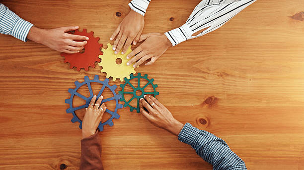 istock Above, hands and business people with gears for  collaboration, solution and support. Solidarity, employees or team building with space, synergy and problem solving with puzzle system in office 2229571169