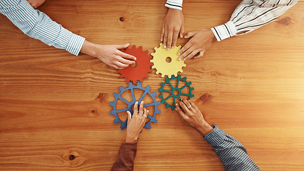 istock Above, hands and business people with gears for solidarity, solution and support. Collaboration, employees or team building with space, system and pattern problem solving with link puzzle in office 2229571172