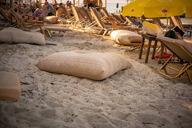 Sunbathing cushion on warm sandy beach — seaside comfort, summer vacation, tropical relaxation, coastal holiday scene