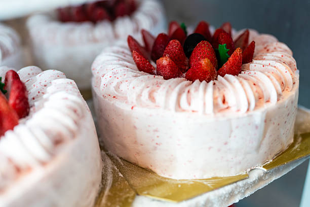 Strawberry ice cream cake in freezer display in shop