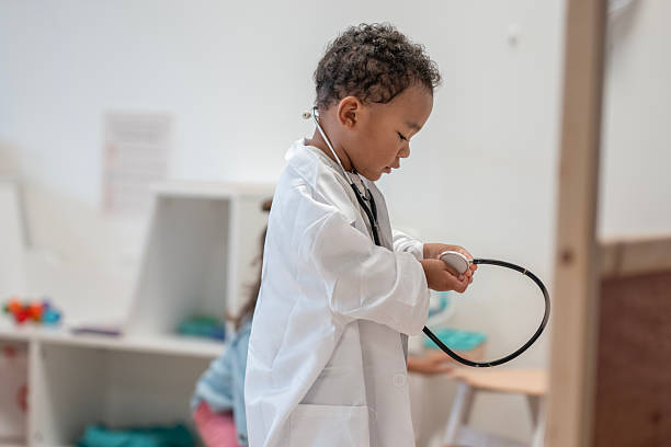 istock Young Child Pretending to Be a Doctor in a Classroom Setting 2229576977