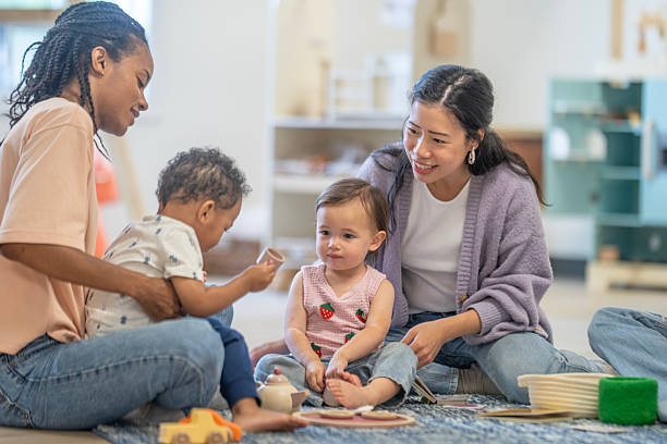 istock Diverse Mothers Engaged in Play with Toddlers in Bright Learning Environment 2229577034