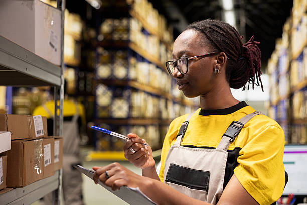 istock African american female worker checking tracking numbers tags 2229577259